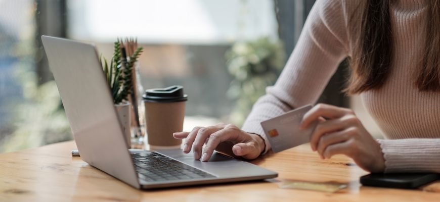 Frau im Cafe zahlt per Online Banking
