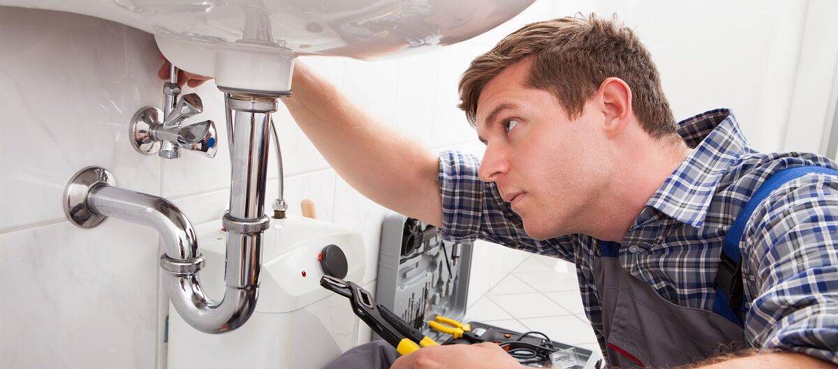 Handwerker repariert Waschbecken