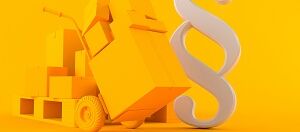 Paragraphenzeichen mit Karre voller Kartons vor gelbem Hintergrund